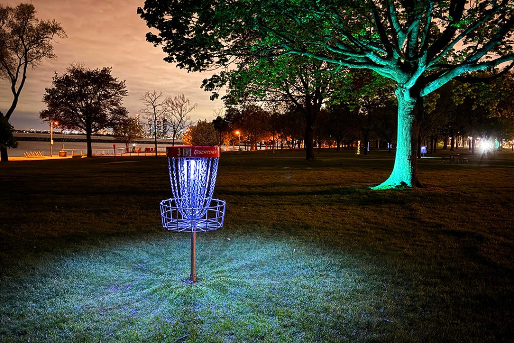Beginner-friendly glow-in-the-dark disc golf played at night using glowing discs and lit baskets, requiring minimal equipment and welcoming players of all skill levels.