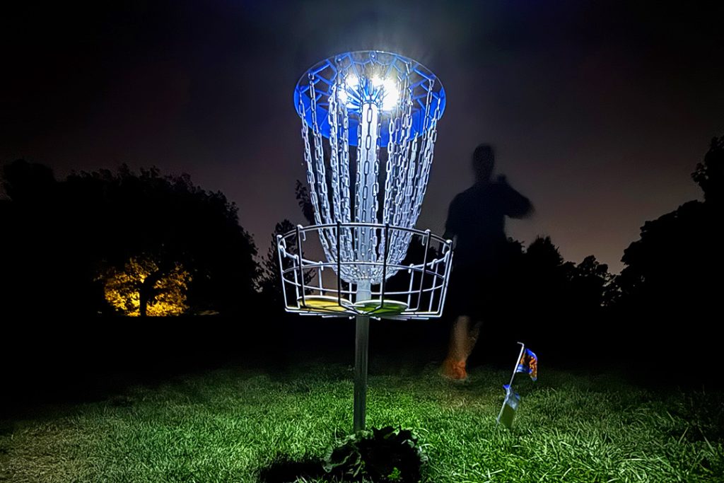 Beginner-friendly glow-in-the-dark disc golf played at night using glowing discs and lit baskets, requiring minimal equipment and welcoming players of all skill levels.