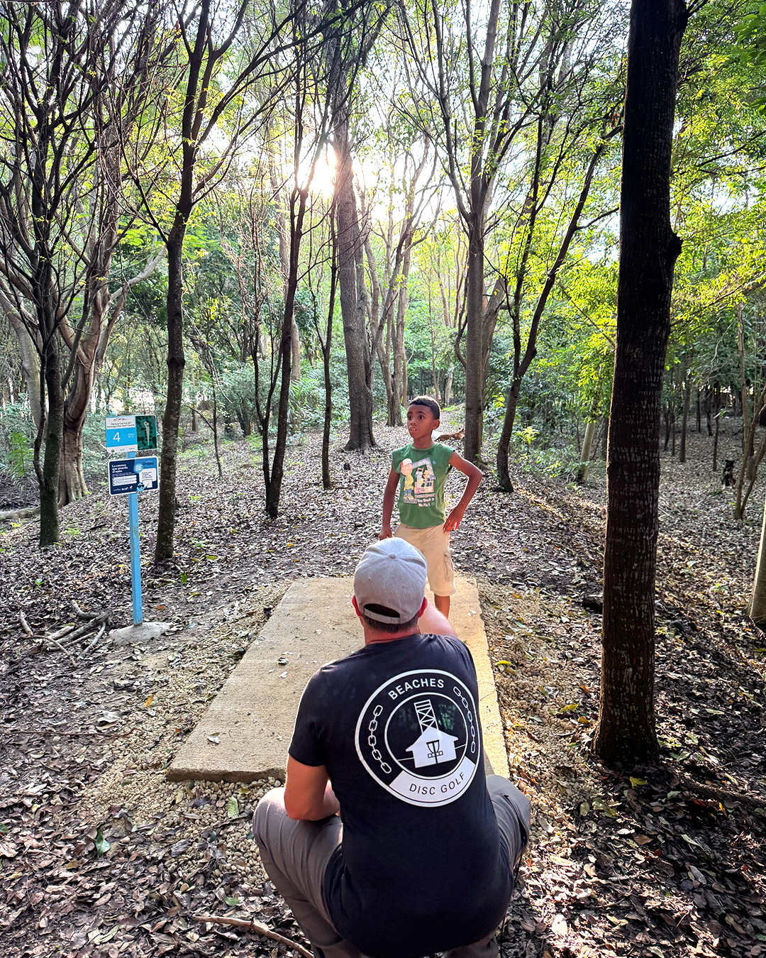 A young child from Santiago de los Caballeros trying disc golf for the first time at Parque Central, as part of the Paul McBeth Foundation's grand opening of the Dominican Republic's first disc golf courses.