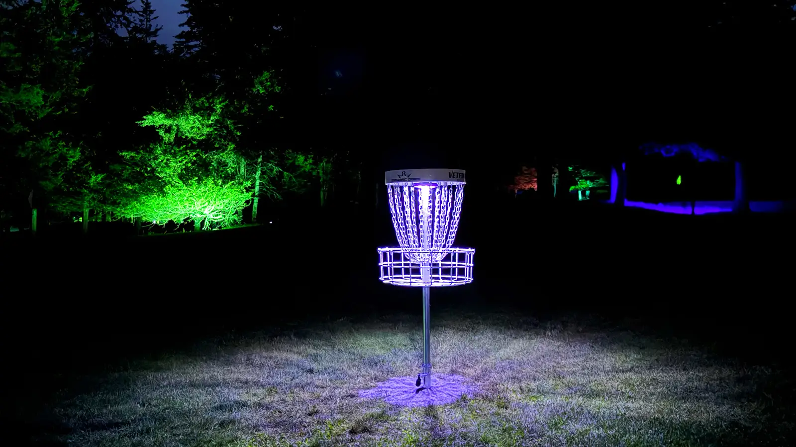 Glowing disc golf basket at Black Bear Ridge Forest & Fairways course