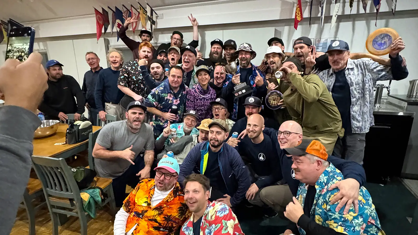 Large group of Glow Down Cup players celebrating indoors at the awards ceremony afterparty