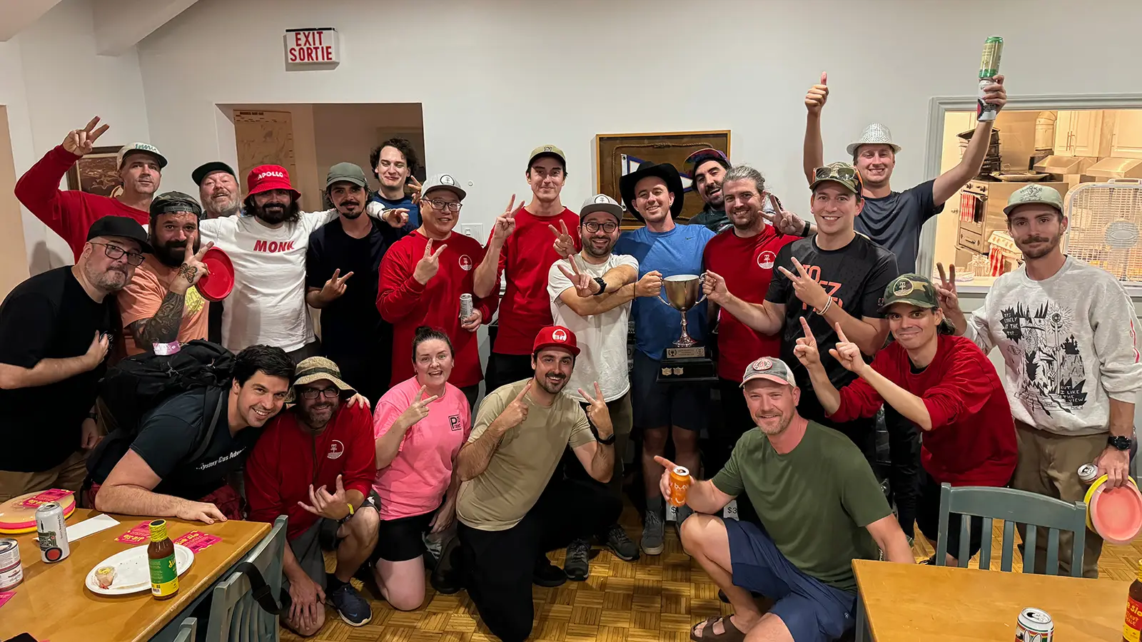 Team Bell players celebrating indoors with the Glow Down Cup trophy